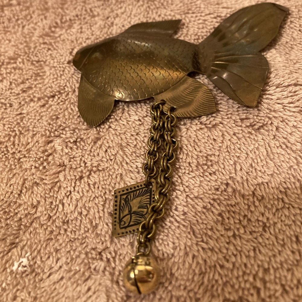 Brass coy brooch